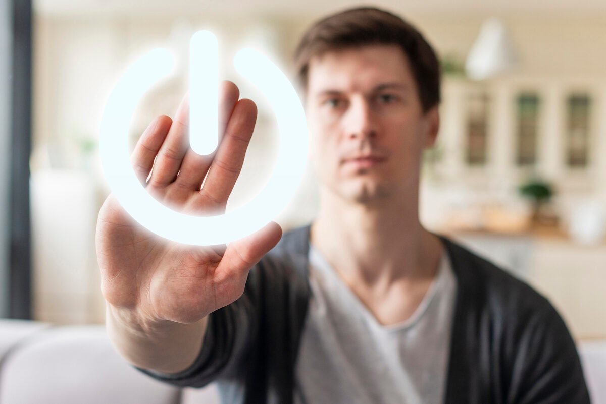 A hand reaching toward a glowing reset symbol